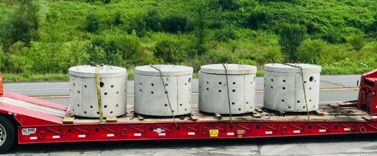 truck transporting concrete cylinders